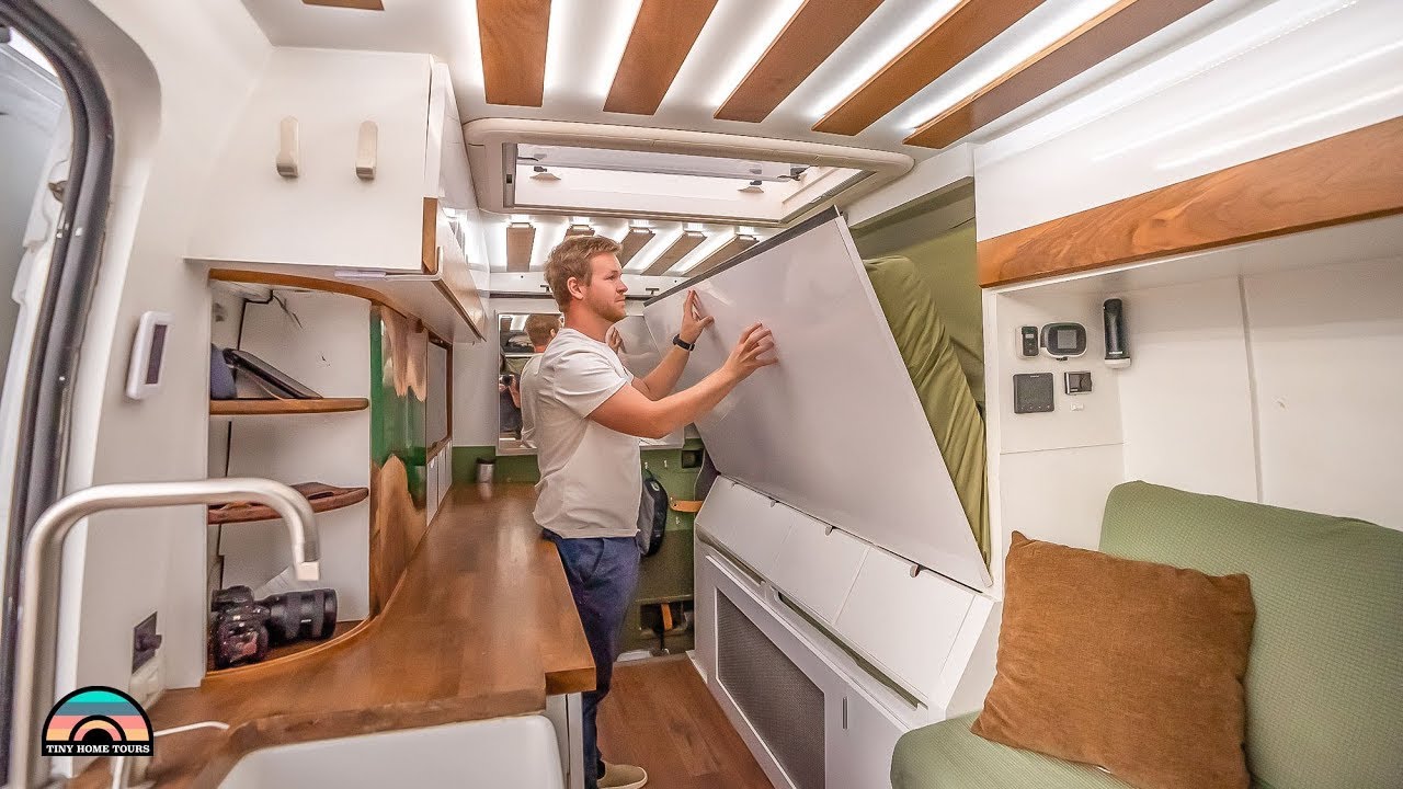Cleverly designed camper van with Murphy bed, office, and Tesla power system